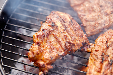 Image showing close up of barbecue meat roasting on grill