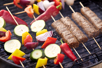 Image showing close up of barbecue kebab meat roasting on grill