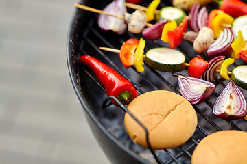 Image showing vegetables and burger buns roasting on grill