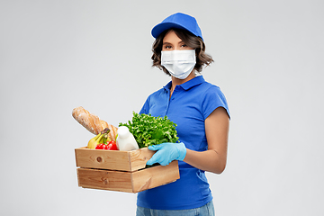 Image showing delivery woman in face mask with food in box