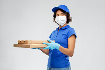 Image showing delivery woman in face mask with pizza boxes