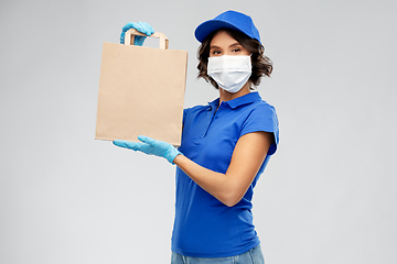 Image showing delivery woman in face mask with food in paper bag