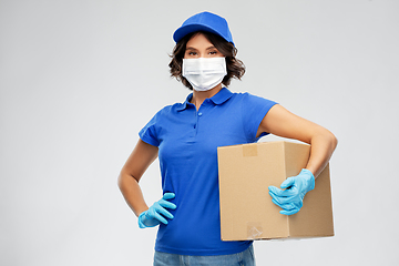 Image showing delivery woman in face mask holding parcel box