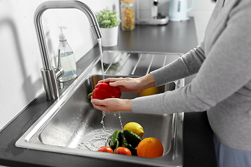 Image showing woman washing fruits and vegetables in kitchen