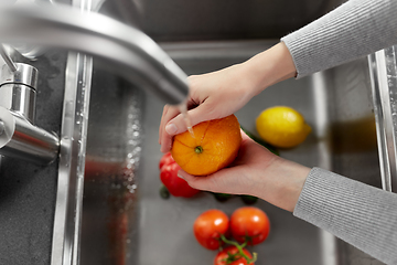 Image showing woman washing fruits and vegetables in kitchen