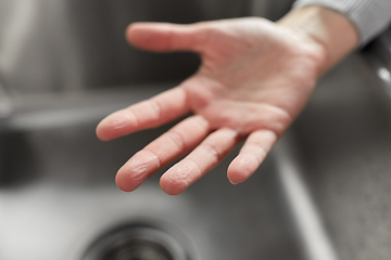Image showing close up of clean woman's hand over kitchen sink
