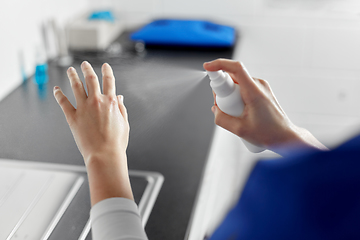 Image showing doctor or nurse spraying hand sanitizer