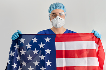 Image showing doctor in goggles and mask holding flag of america