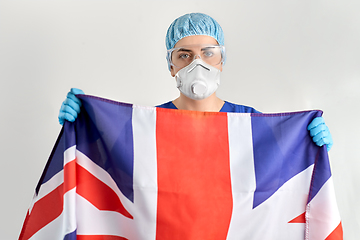 Image showing doctor in goggles and mask holding flag of america