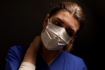 Image showing tired female doctor or nurse in medical face mask