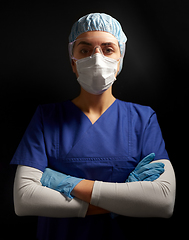 Image showing female doctor or nurse in goggles and face mask