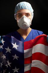 Image showing doctor in goggles and mask holding flag of america