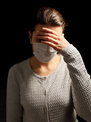 Image showing sick young woman in protective medical face mask
