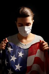 Image showing sick woman in face mask holding flag of america