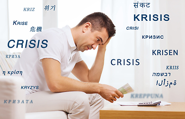 Image showing stressed man with money and calculator at home