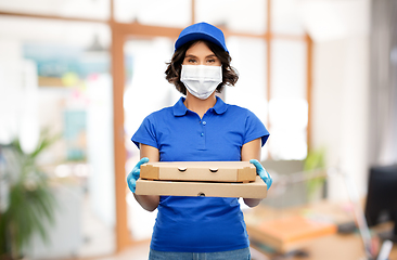 Image showing delivery woman in mask with pizza boxes at office