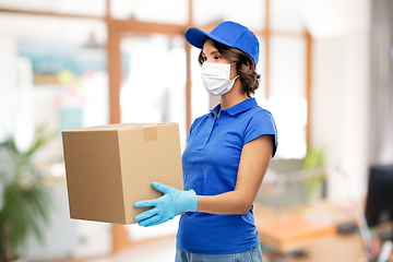 Image showing delivery woman in mask with parcel box at office