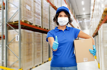 Image showing delivery woman in mask with box at warehouse