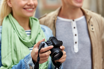 Image showing close up of smiling couple with digital camera