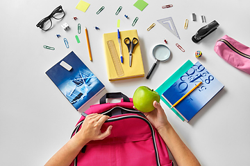 Image showing hands with backpack, books and school supplies