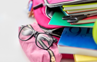 Image showing backpack, apple and school supplies on table