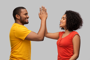 Image showing happy african american couple making high five