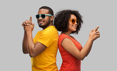 Image showing african couple in sunglasses making gun gesture