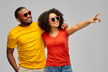 Image showing happy african couple in heart shaped sunglasses