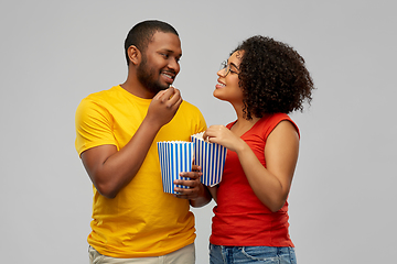 Image showing happy african american couple eating popcorn