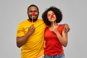 Image showing happy african american couple with red clawn noses