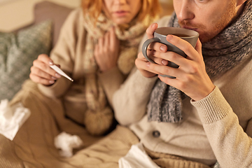 Image showing close up of sick young couple drinking tea at home