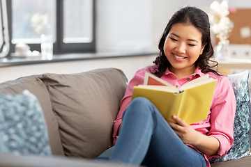 Image showing asian young woman reading book at home