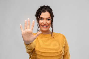 Image showing happy woman in pullover showing five fingers