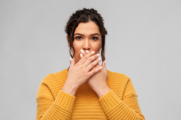 Image showing scared woman clothing her mouth with hands