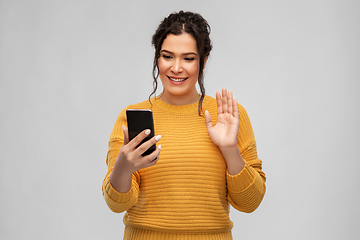 Image showing happy young woman having video call on smartphone