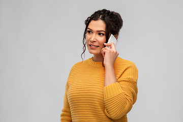 Image showing happy young woman calling on smartphone