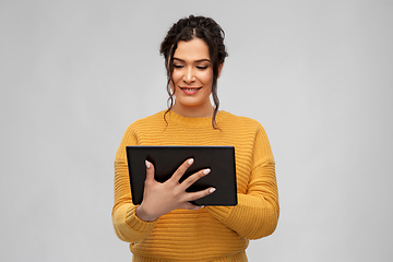 Image showing happy young woman using tablet pc computer