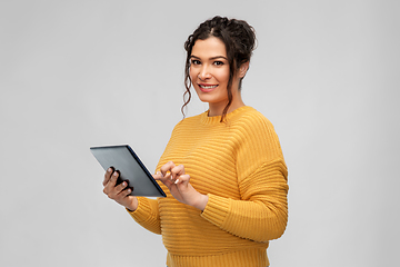 Image showing happy young woman using tablet pc computer