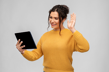 Image showing happy young woman having video call on tablet pc