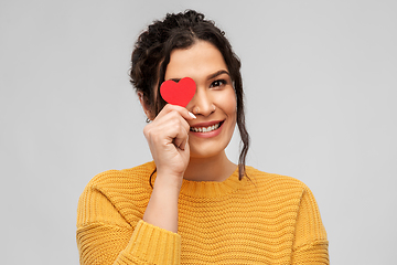 Image showing happy smiling young woman with red heart