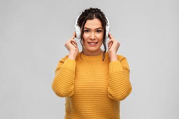 Image showing happy woman in headphones listening to music