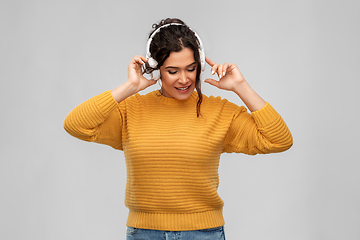 Image showing happy woman in headphones listening to music