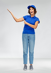 Image showing happy smiling delivery woman in blue uniform