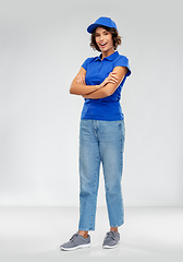 Image showing happy smiling delivery woman in blue uniform