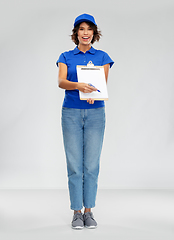 Image showing happy smiling delivery woman with clipboard