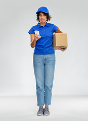 Image showing delivery woman with smartphone and parcel box