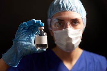 Image showing close up of doctor's hand with bottle of medicine