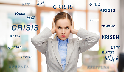 Image showing stressed businesswoman with covered ears in crisis