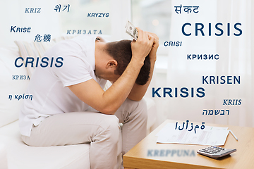 Image showing stressed man with money and calculator at home