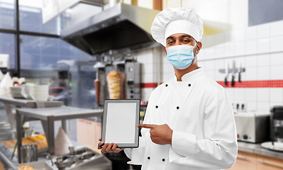 Image showing male chef in face mask with tablet pc at kitchen